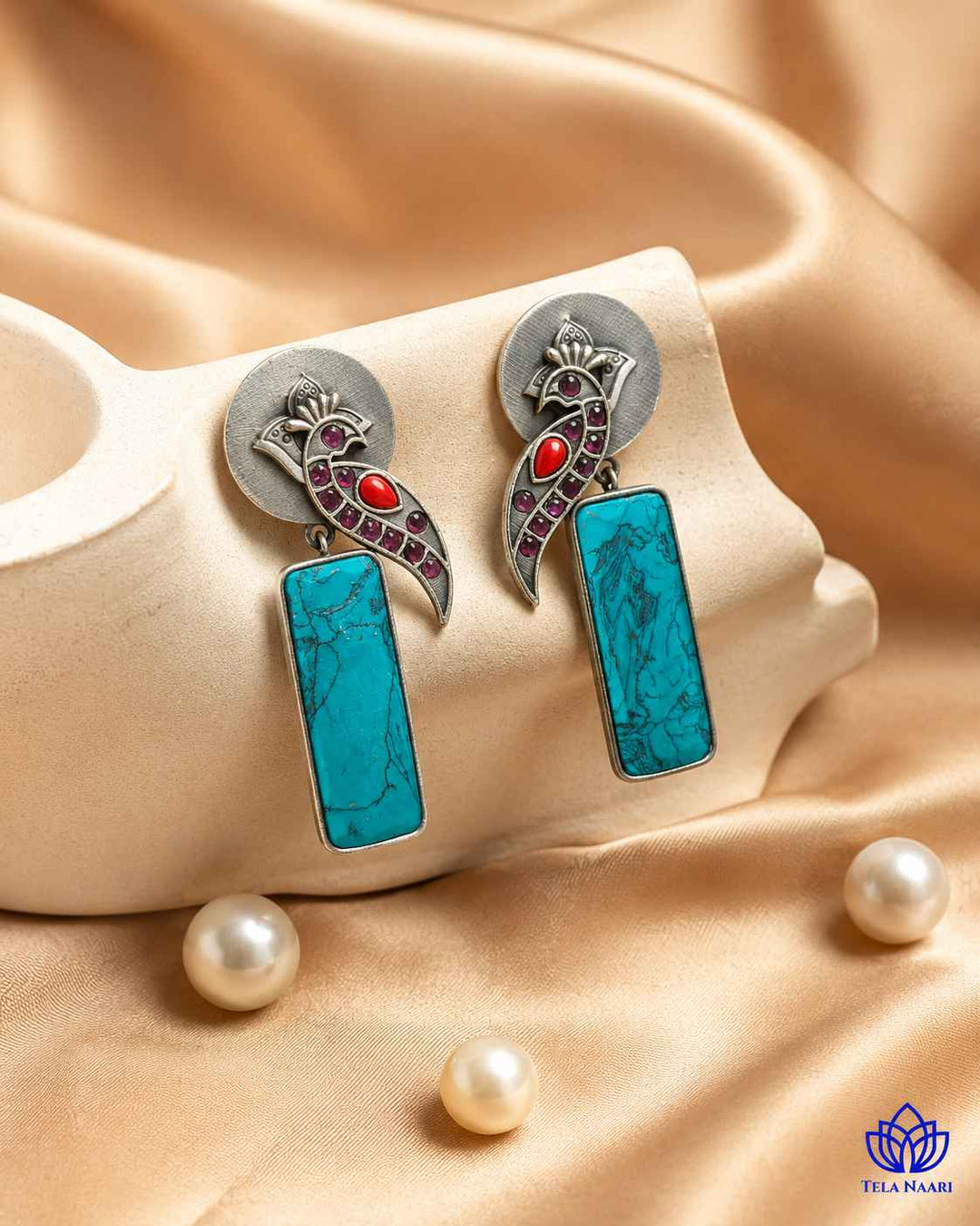 Intricate glass bead detailing decorates the surface of this earring.