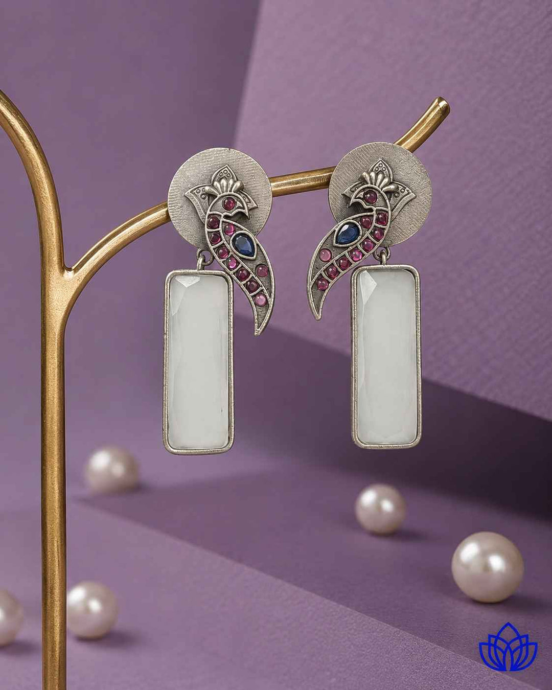 Brass construction supports the handmade design of this earring.