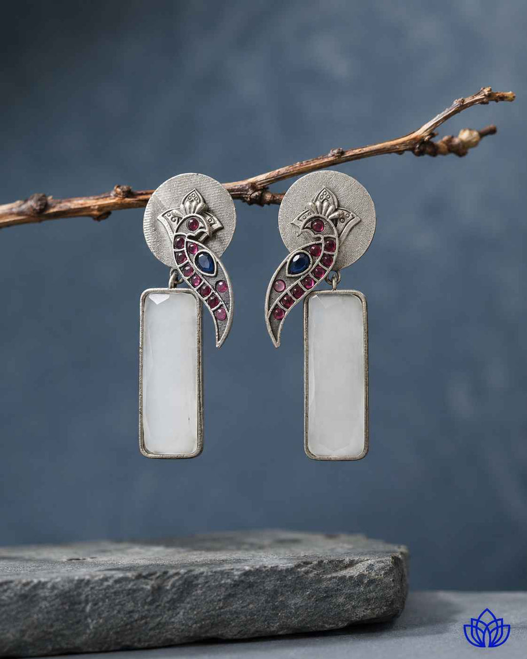 Glass bead detailing decorates the surface of this white earring.