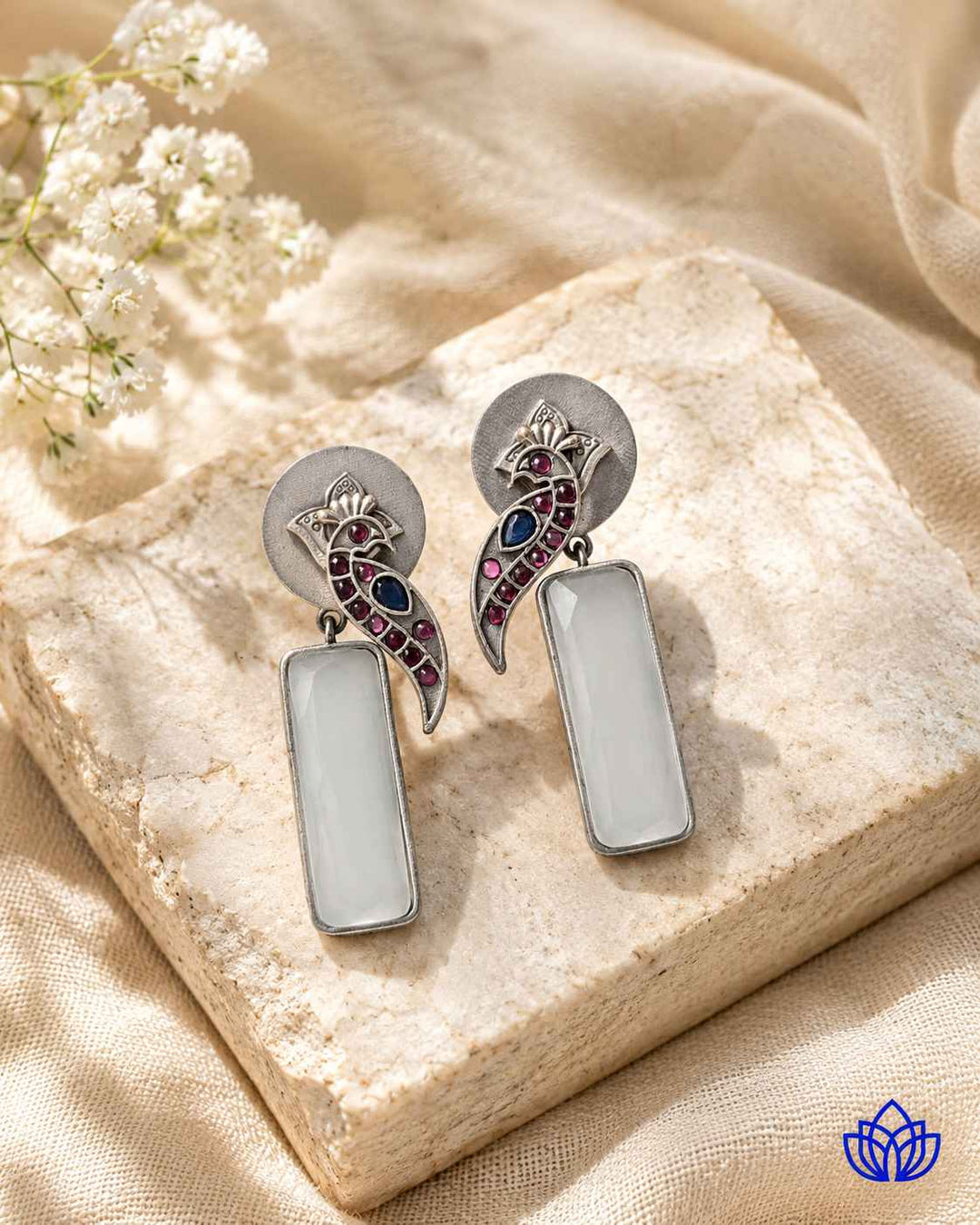 Handmade craftsmanship gives this white earring its intricate charm.