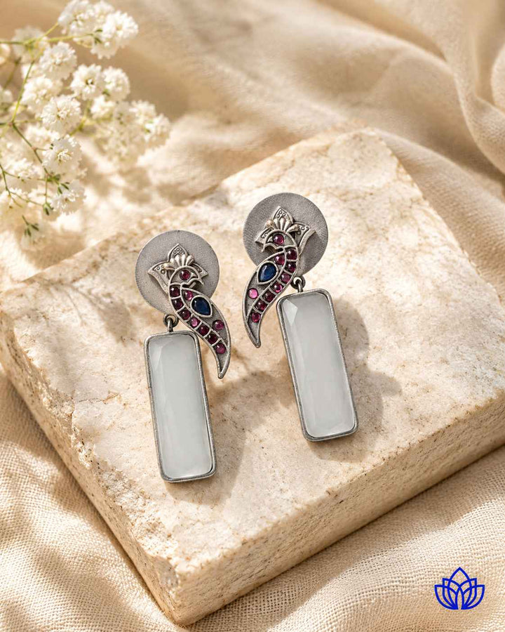Handmade craftsmanship gives this white earring its intricate charm.