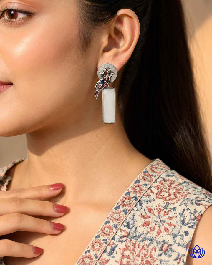 Post and back closure secures this silver-plated white earring.