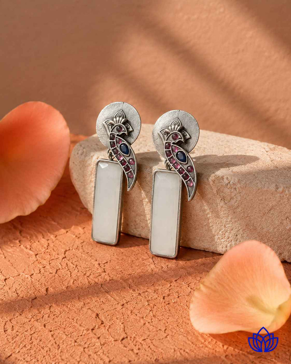 Silver-plated finish covers the surface of this white earring.
