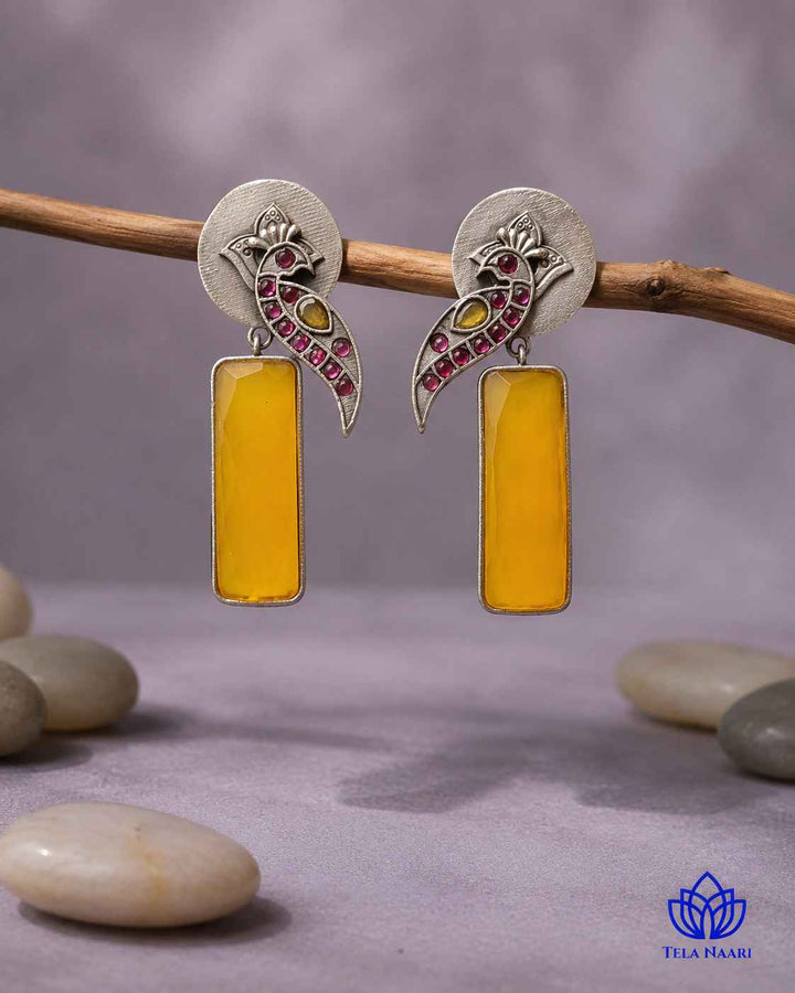 Delicate stone work highlights the intricate design of this earring.