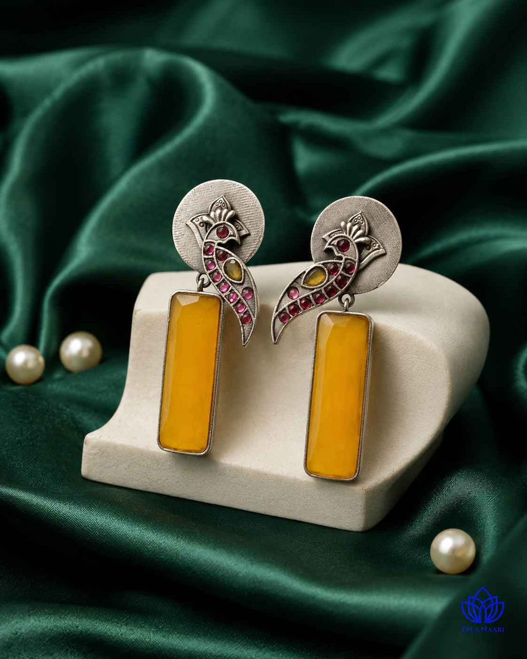 Sunlit yellow detailing decorates the surface of this earring.
