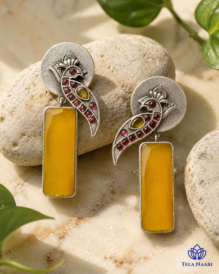 Glass bead detailing decorates the surface of this yellow earring.