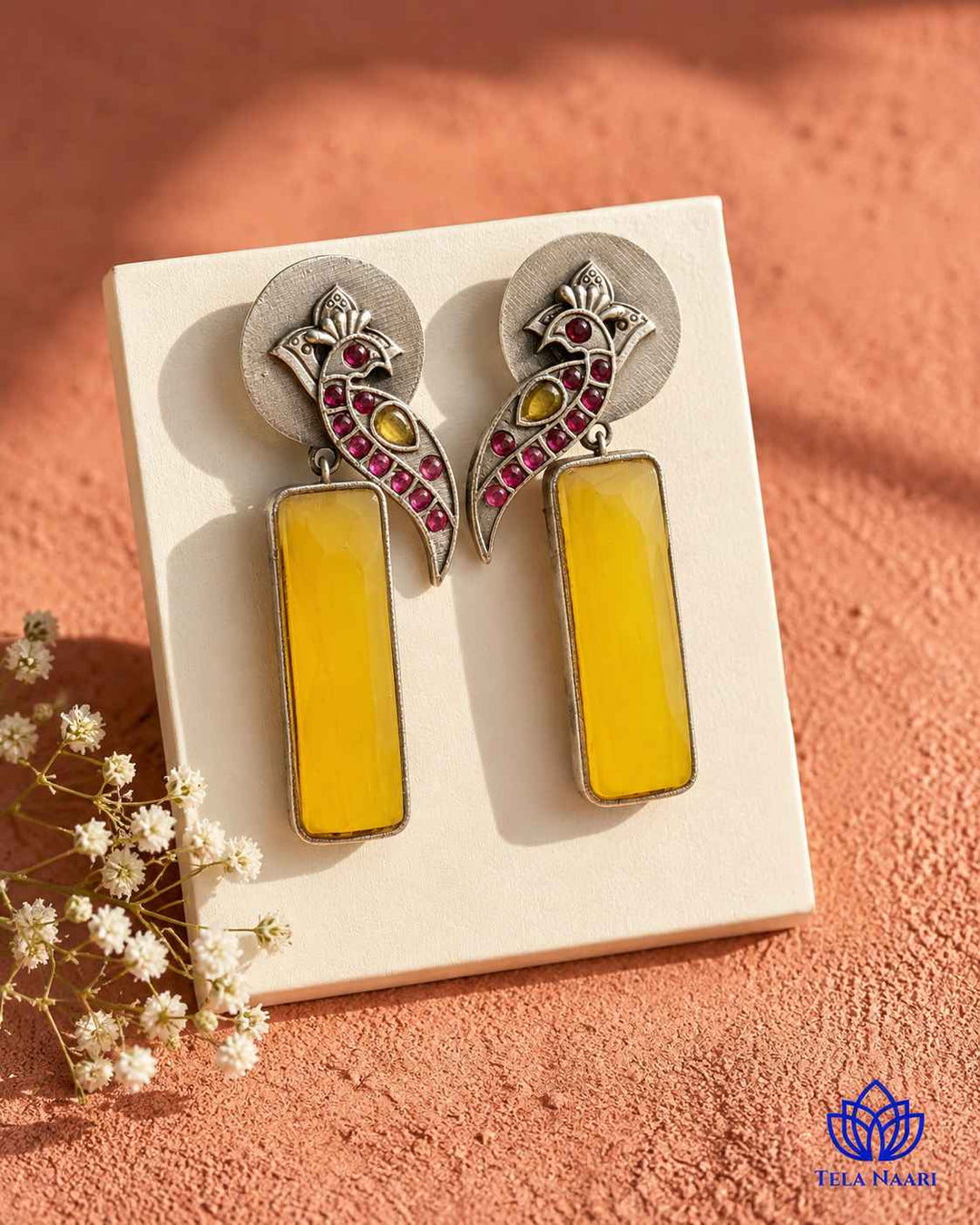 Handmade craftsmanship gives this yellow earring its intricate charm.