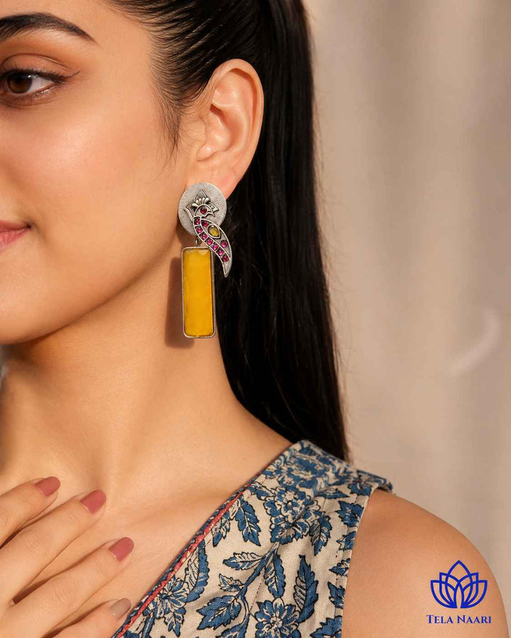 Post and back closure secures this silver-plated yellow earring.