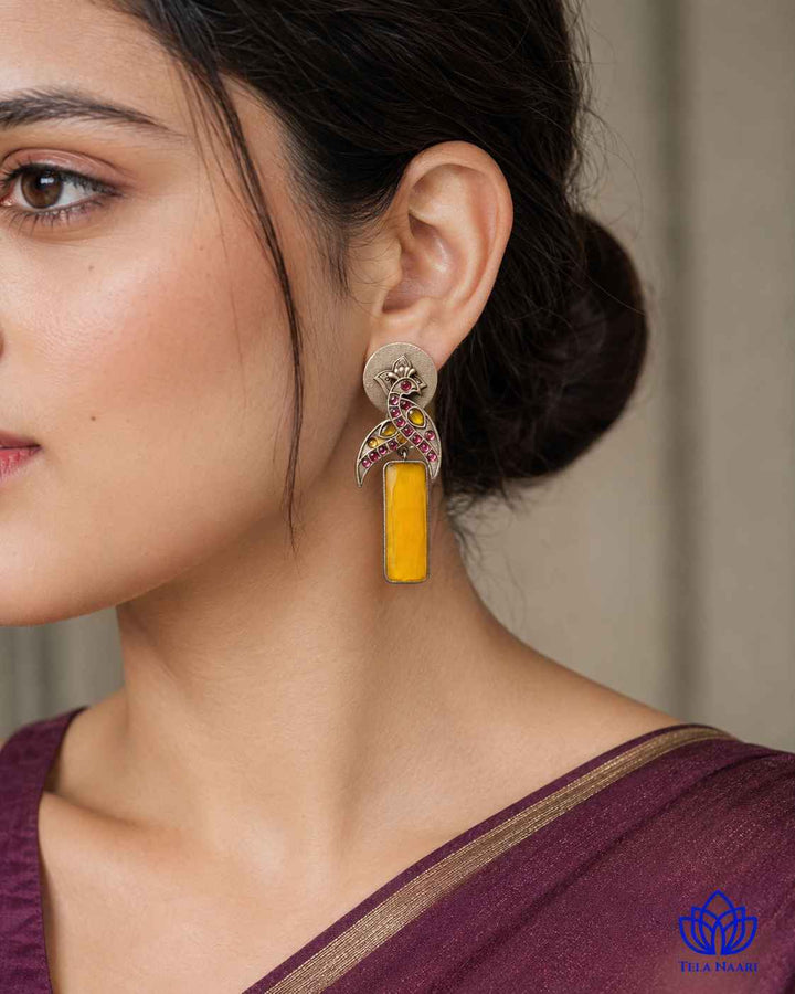 Versatile design pairs a silver-plated finish with yellow stones.