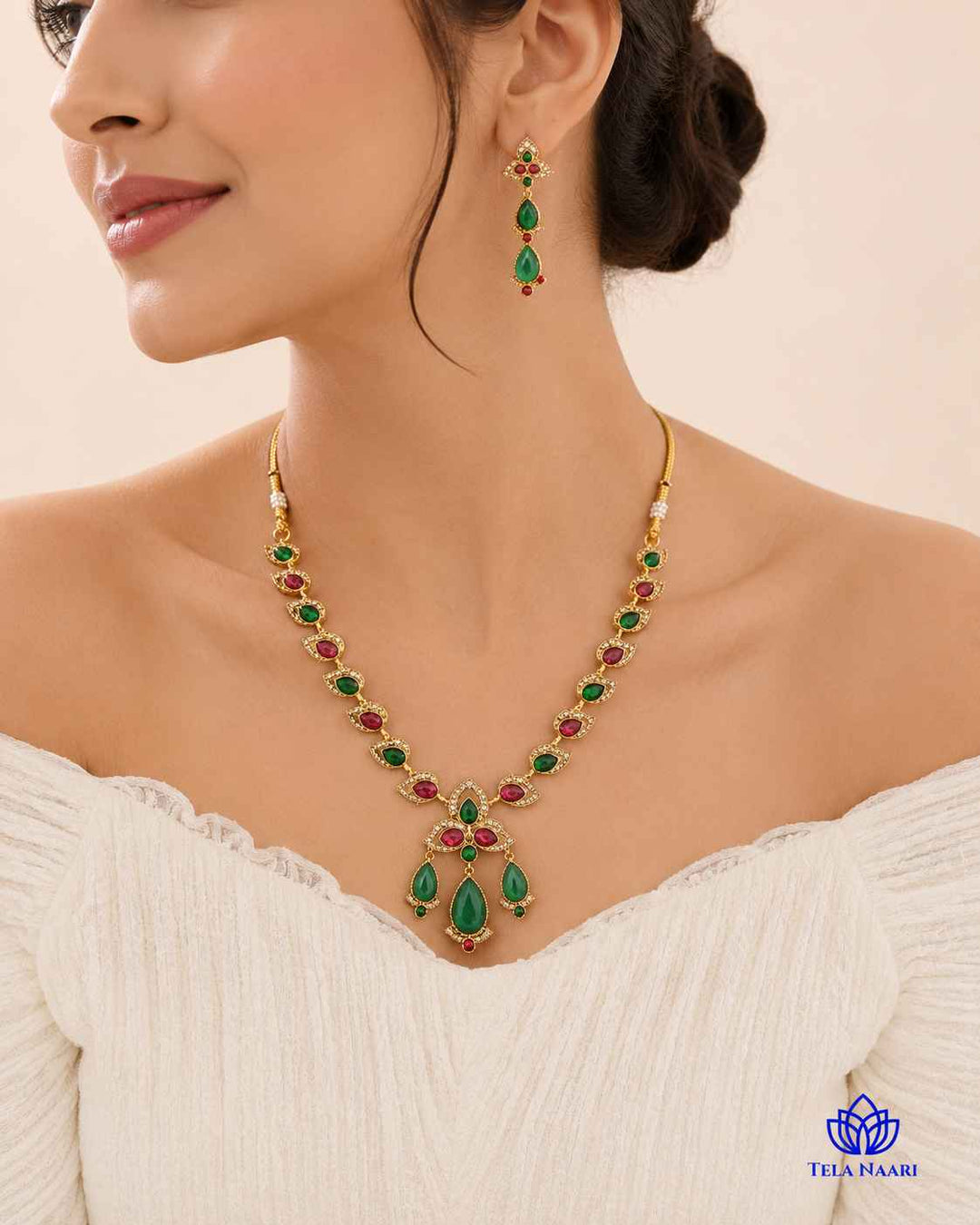 Red and green stones decorate the surface of this necklace.