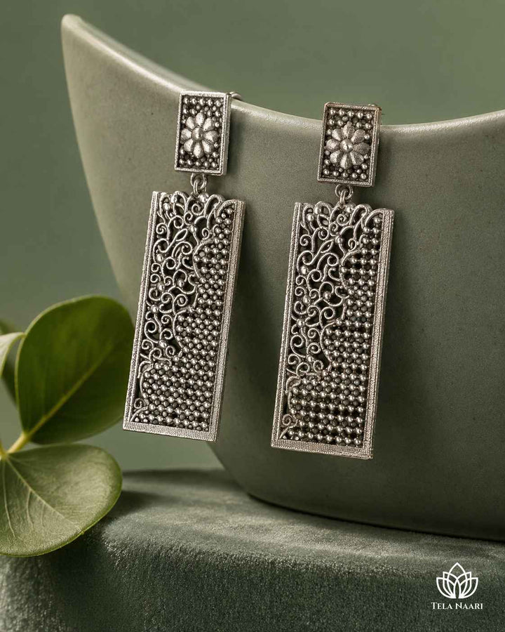Lightweight brass earrings by Tela Naari finished with a polished silver-plated teardrop design.