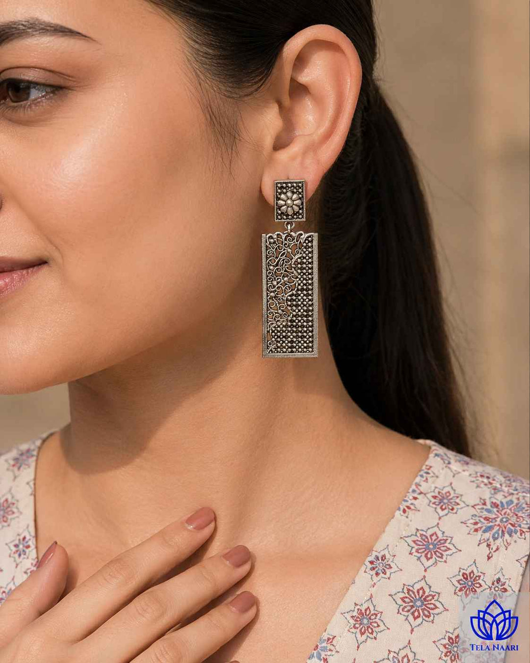 Rounded teardrop silhouette pairs with a smooth silver-plated brass finish.
