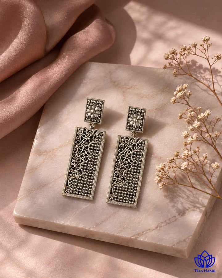 Polished silver-plated finish covers the rounded teardrop shape of this earring.