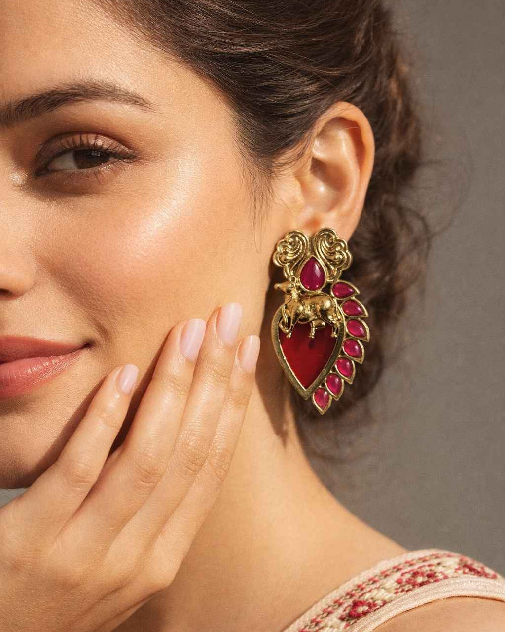 Brass construction supports the layered stud design of this earring.