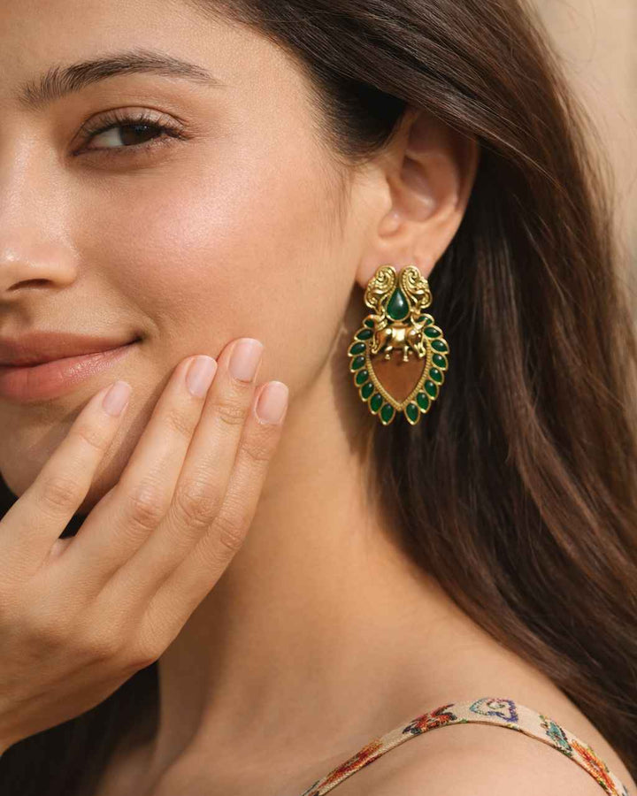 Petite silhouette defines the shape of this dual-tone stud earring.