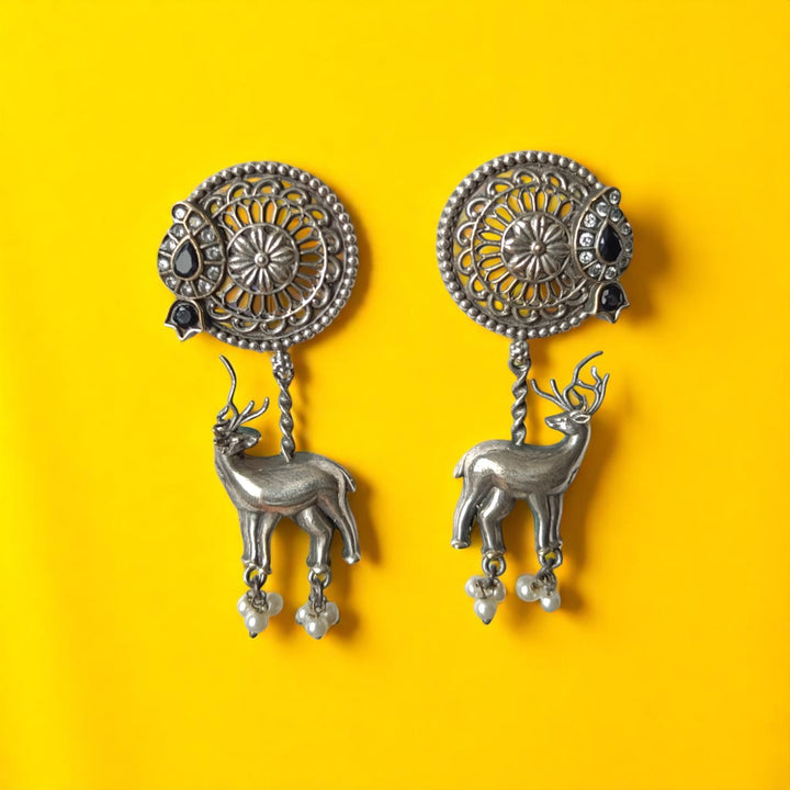 Silver oxidised finish gives this deer charm earring its antique texture.