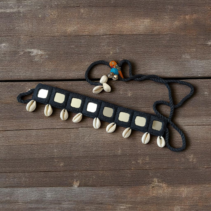 Mirror embellishments catch the light across this black fabric choker.