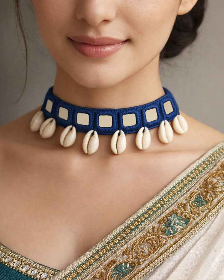 Timeless blue fabric shapes the silhouette of this handmade choker.