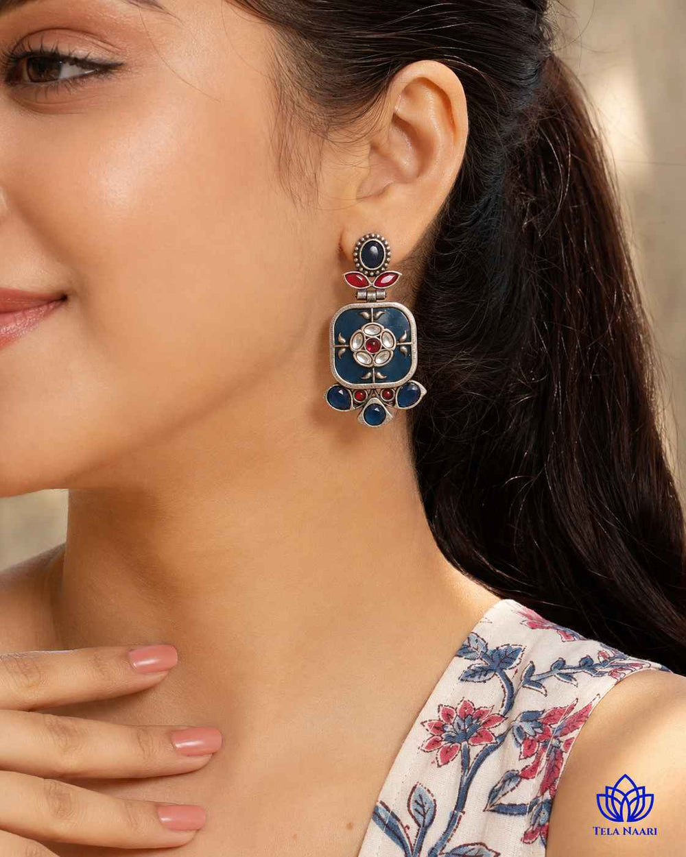 Blue dangler silhouette defines the shape of this earring.