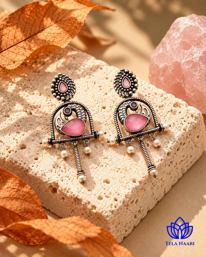Brass construction supports the statement design of this earring.