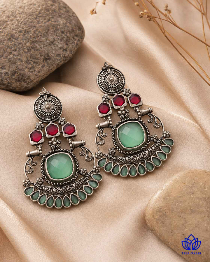 Brass construction supports the stone detailing of this earring.