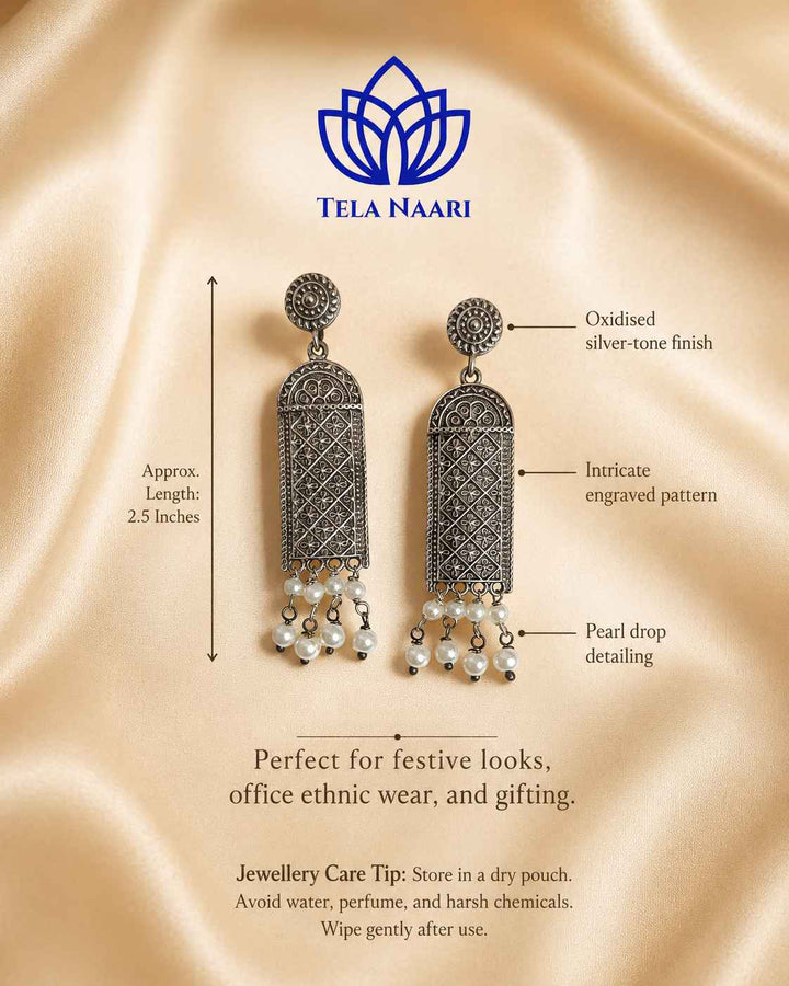 Antique detailing adds texture to this silver-plated earring surface.