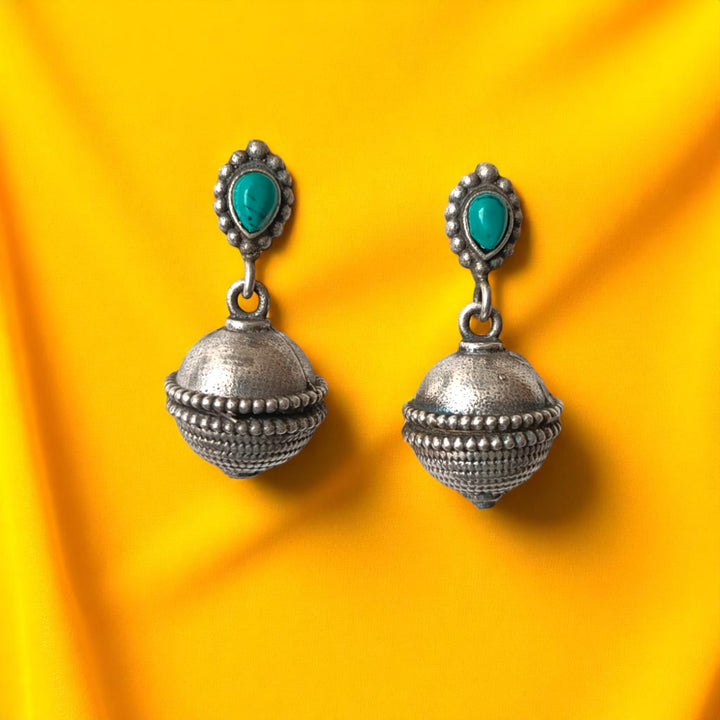 Charming bell drop defines the silhouette of this oxidised earring.