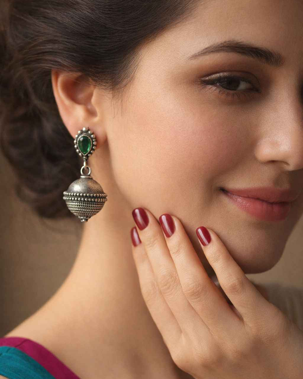 Brass construction supports the oxidised finish of this bell earring.