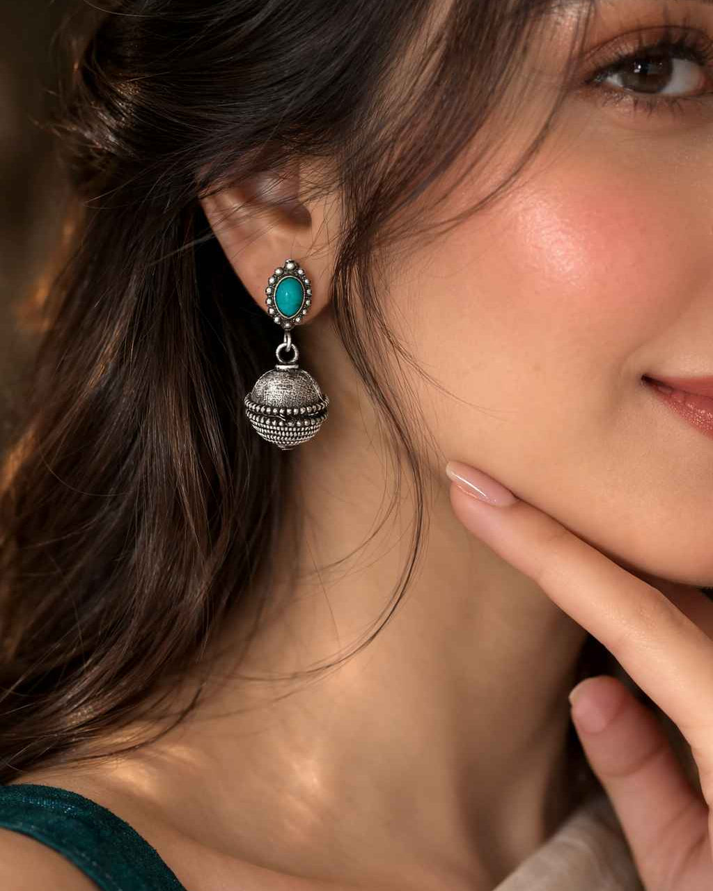 Antique oxidised finish gives this bell drop earring its textured look.