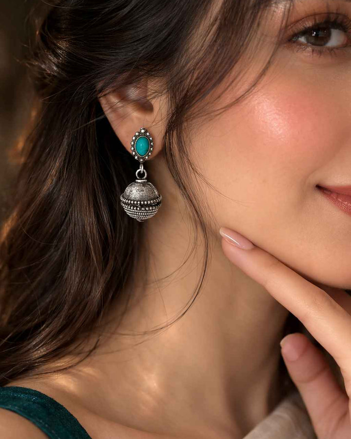 Antique oxidised finish gives this bell drop earring its textured look.