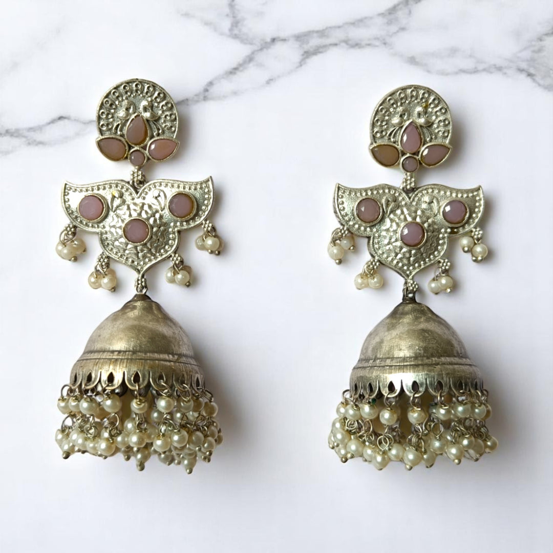 Brass construction supports the intricate oxidised pattern of this earring.