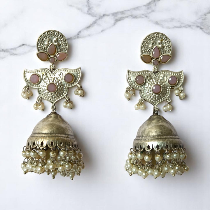 Brass construction supports the intricate oxidised pattern of this earring.