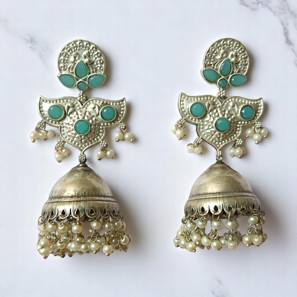 Pink tones brighten the oxidised surface of this statement earring.