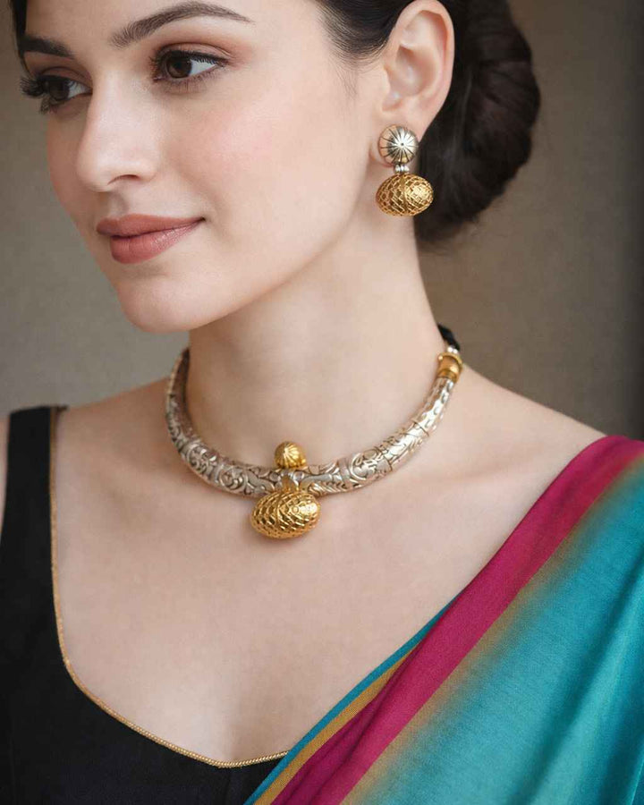 Handcrafted chitai work brings antique detailing to this oxidised necklace set.