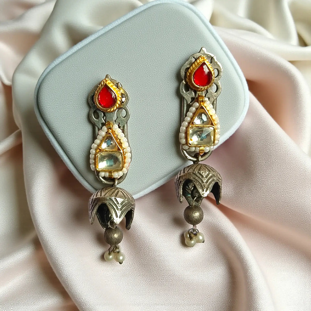 Glass bead detailing decorates the surface of this kundan earring.