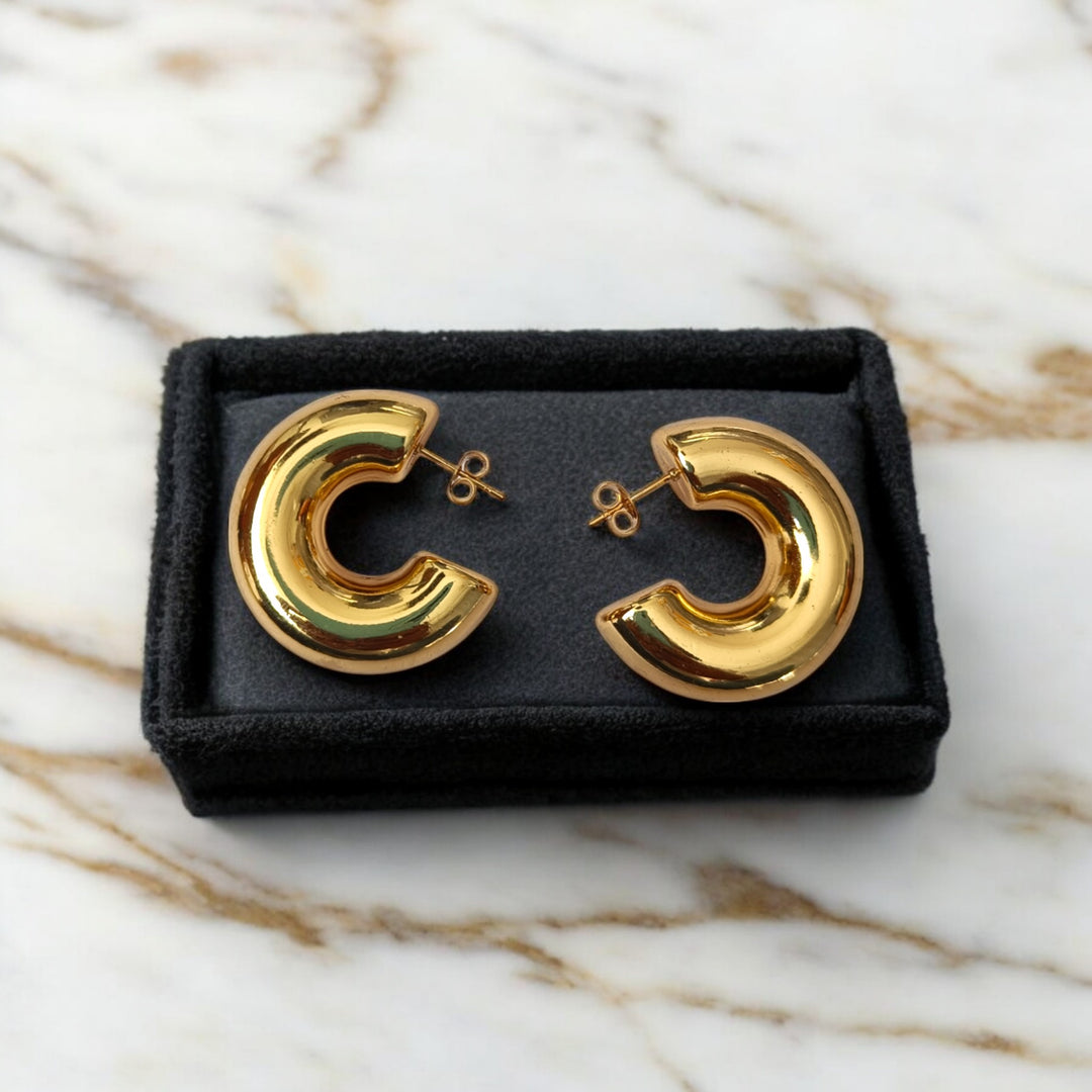 Modern open hoop silhouette defines the shape of this earring.
