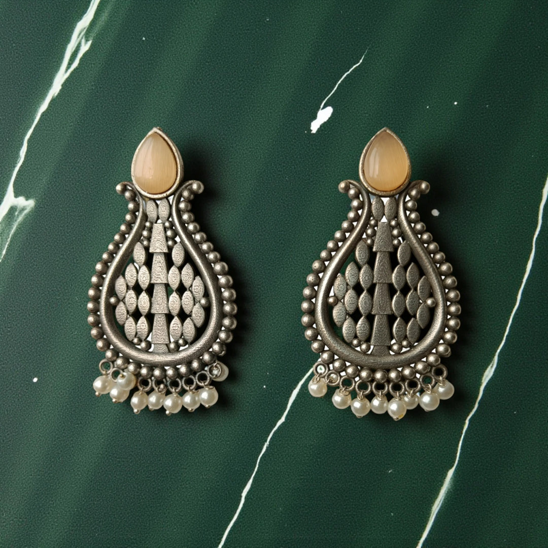 Umeshwari oxidised silver pearl earrings with peach tones — perfect for engagement looks, pastel sarees, and subtle festive charm.
