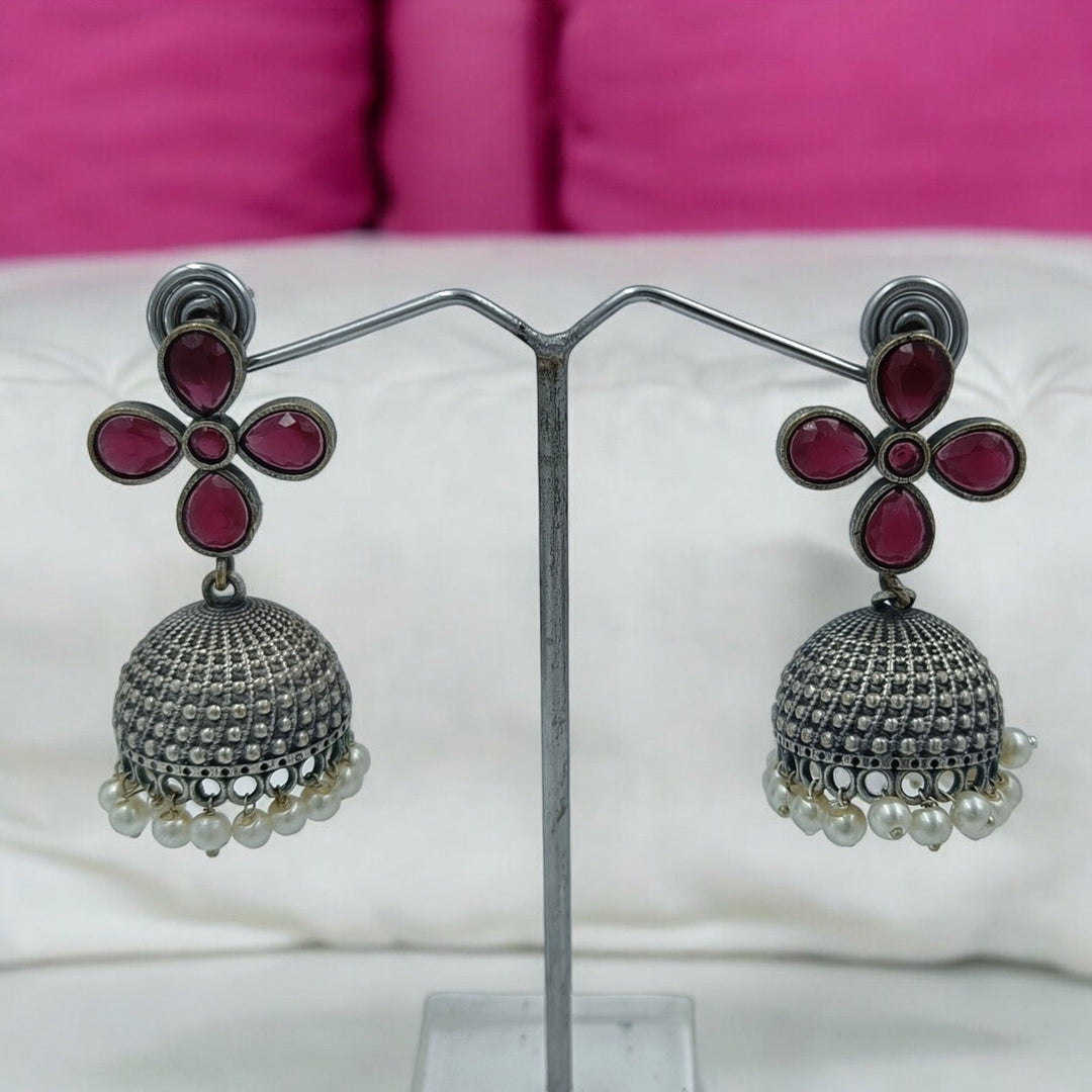 Yogita oxidised silver jhumki earrings in red — bold for party wear, reception functions, and traditional attire.
