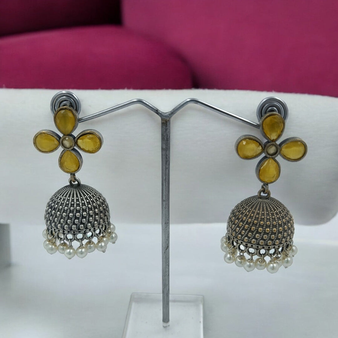 Yogita oxidised silver jhumki earrings in yellow — radiant for daytime celebrations, haldi looks, and sunny festive charm.
