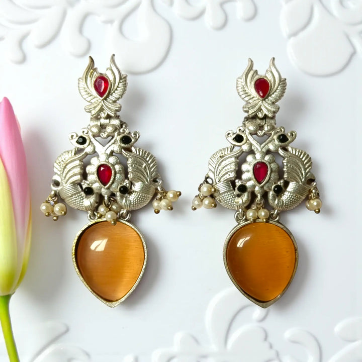 Gyada oxidised silver dangler earrings in peach — graceful option for engagement, pastel outfits, and soft evening wear.
