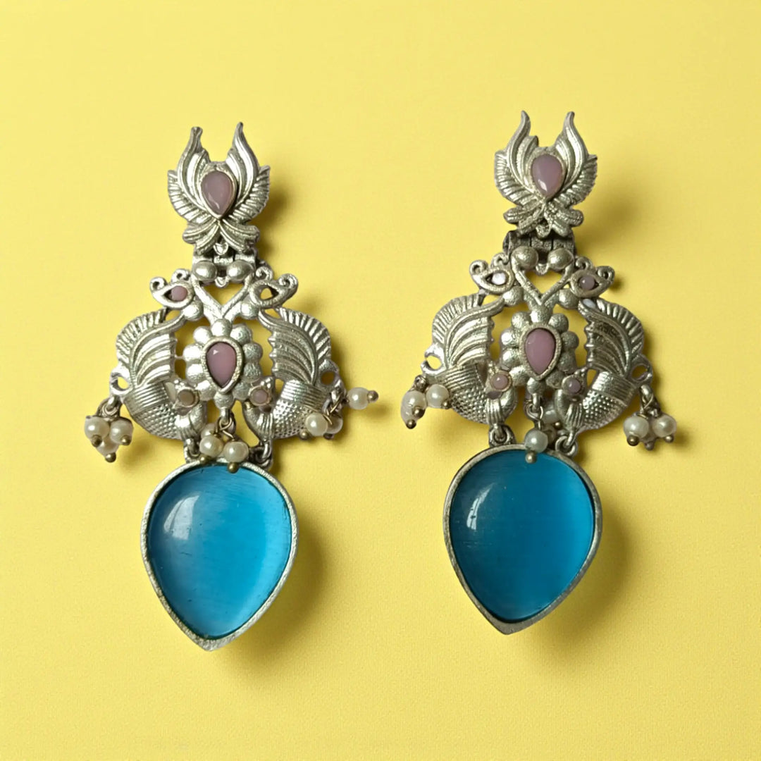 Gyada oxidised silver dangler earrings in sky blue — serene tone for daytime events, brunches, and subtle festive looks.
