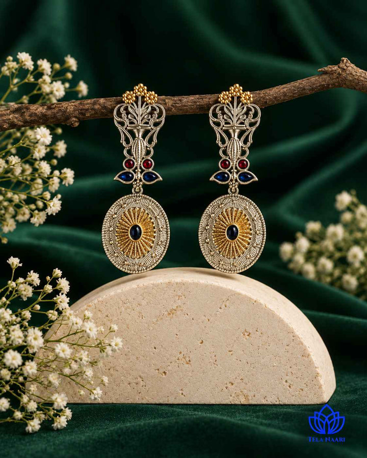 Contemporary aesthetic pairs peacock detailing with metallic contrast.
