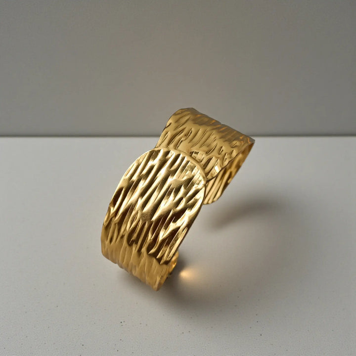Stainless steel construction supports the crinkle texture of this cuff.