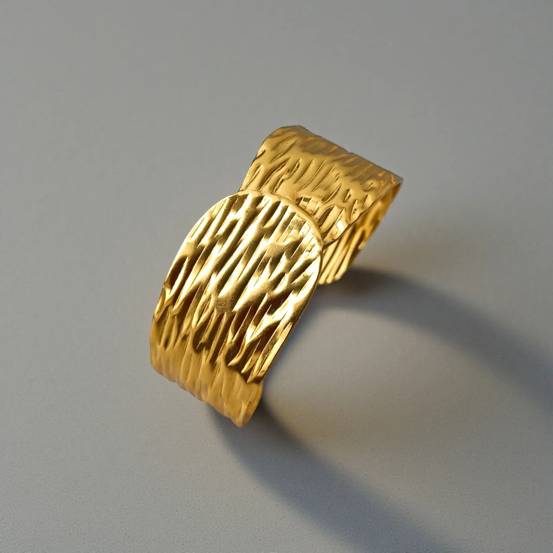 Wide silhouette highlights the crinkled texture of this cuff bracelet.