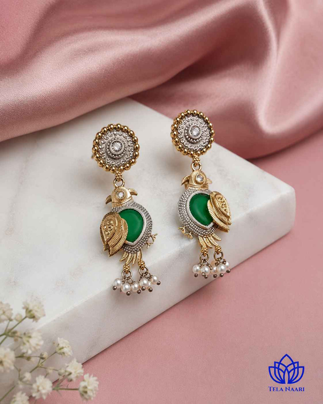 Pearl accents add a soft touch to this dual-tone earring.