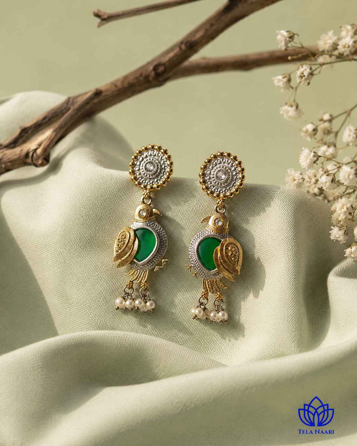 Green tones highlight the dual-tone plating of this bird design.