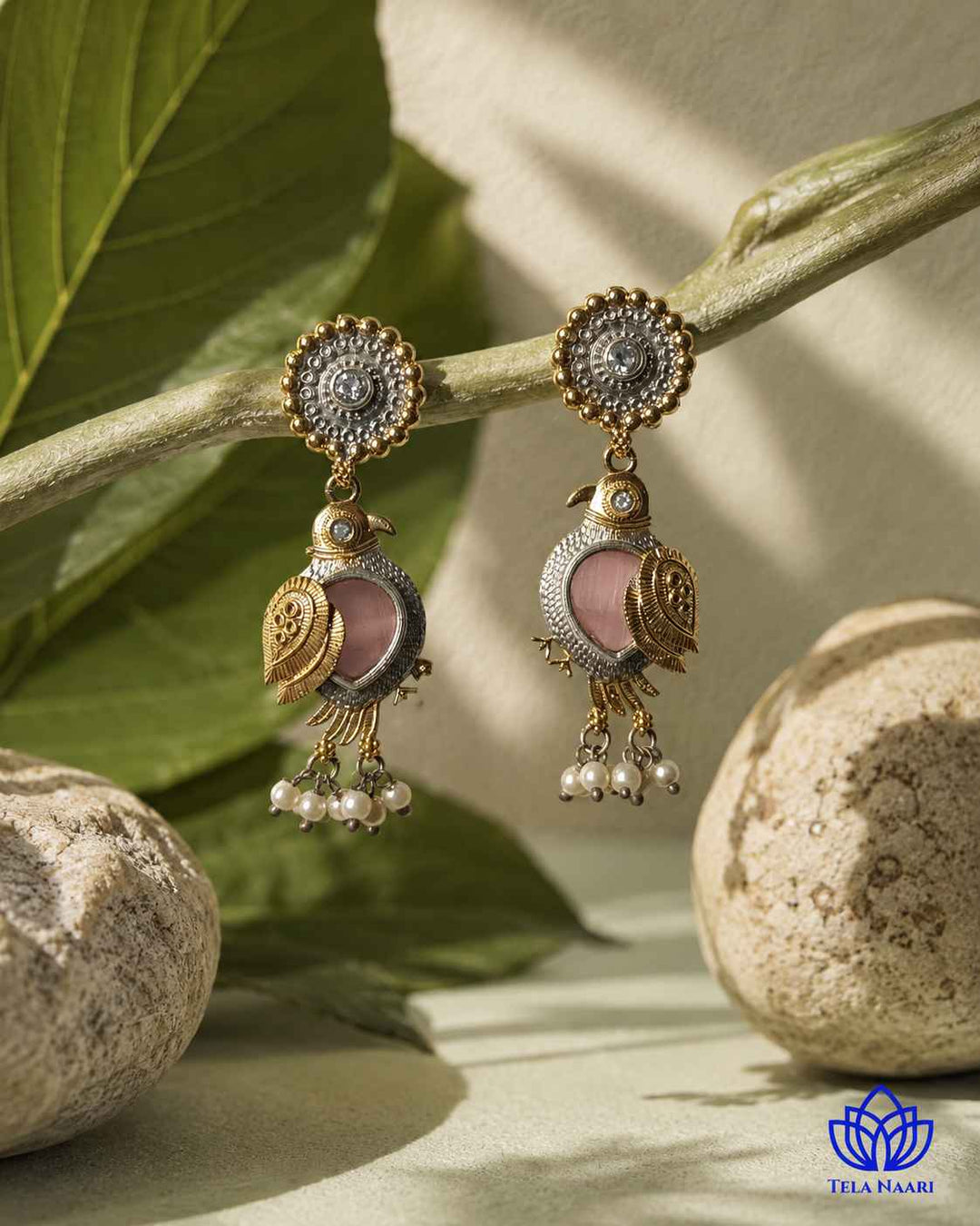 Brass construction supports the nature-inspired bird design of this earring.