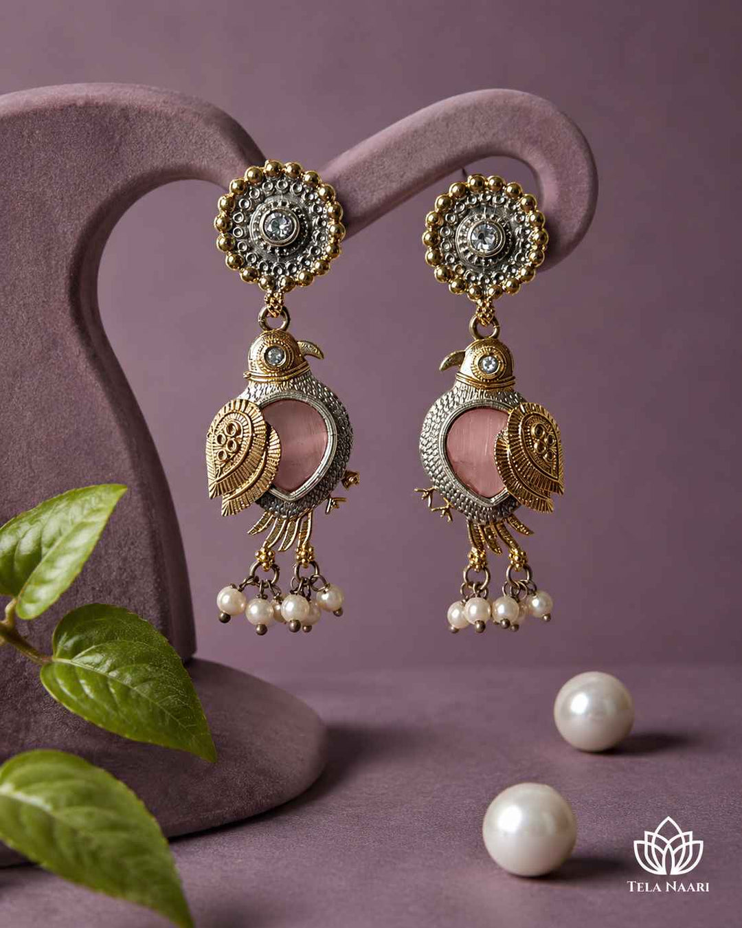 Delicate pearl detailing highlights the design of this earring.