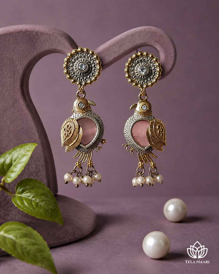 Delicate pearl detailing highlights the design of this earring.