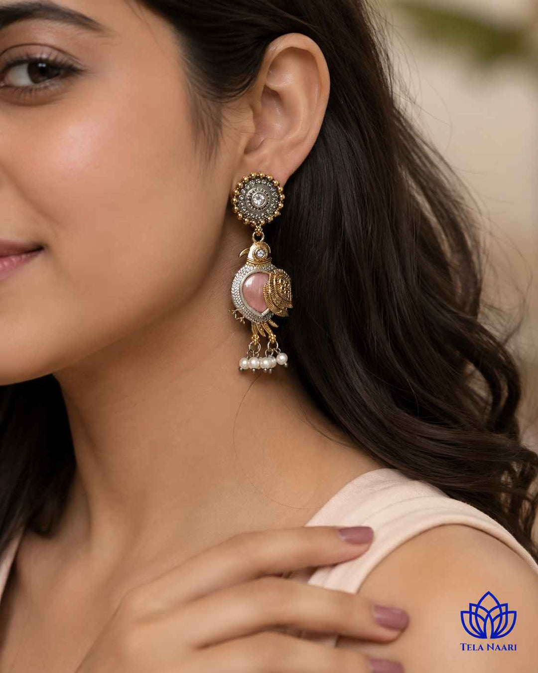 Versatile design pairs a bird motif with pink dual-tone plating.